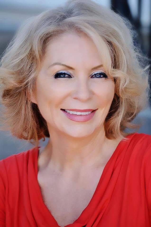 A woman with blonde hair wearing red shirt.